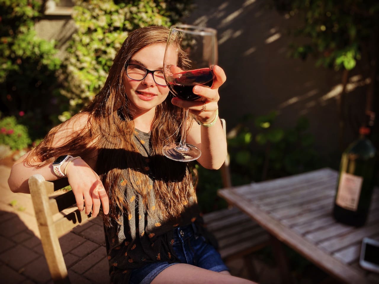 1270BACS Berkeley woman w wine back patio